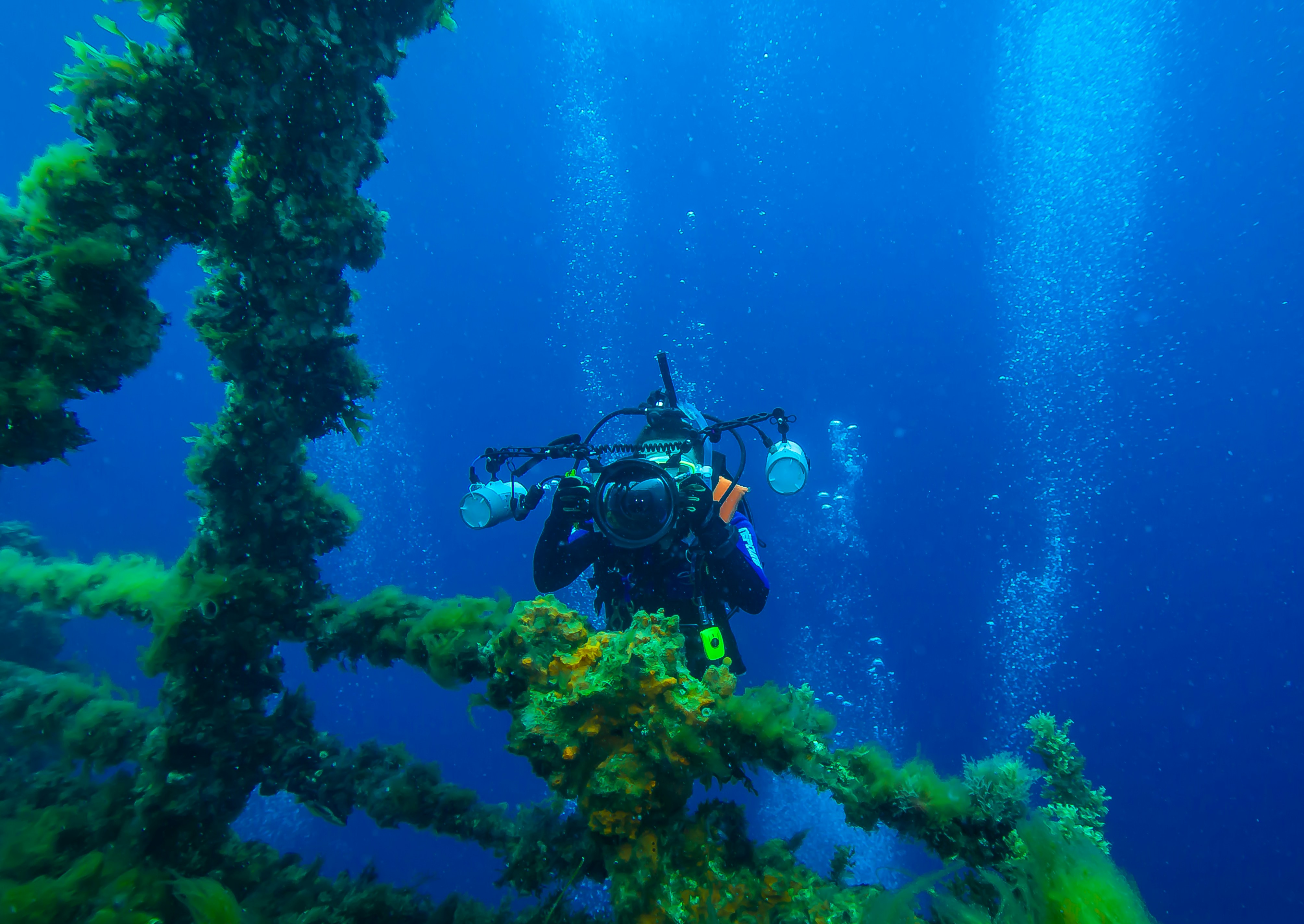 Underwater photographer in scuba gear with camera
