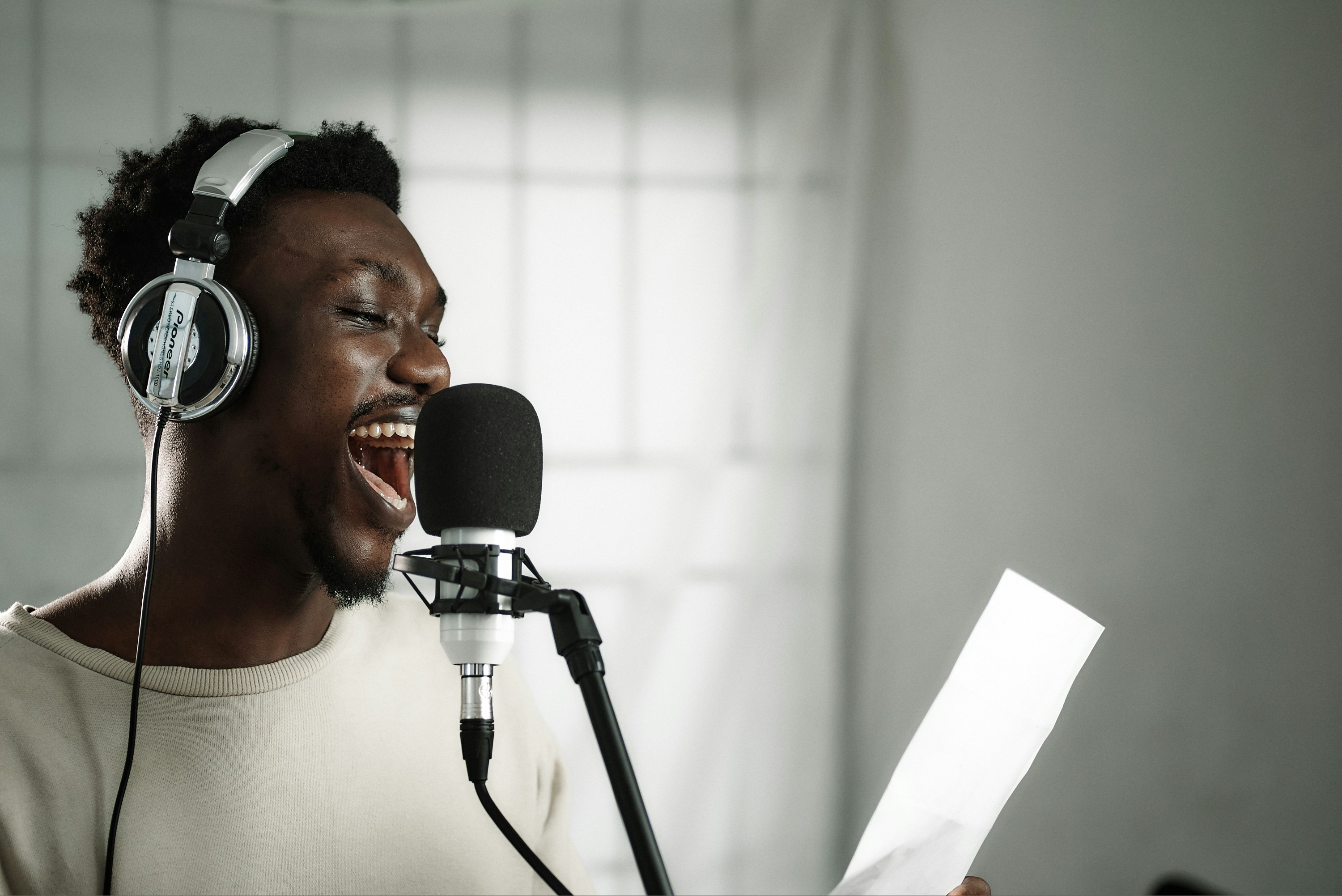  Expressive narrator in headphones with microphone