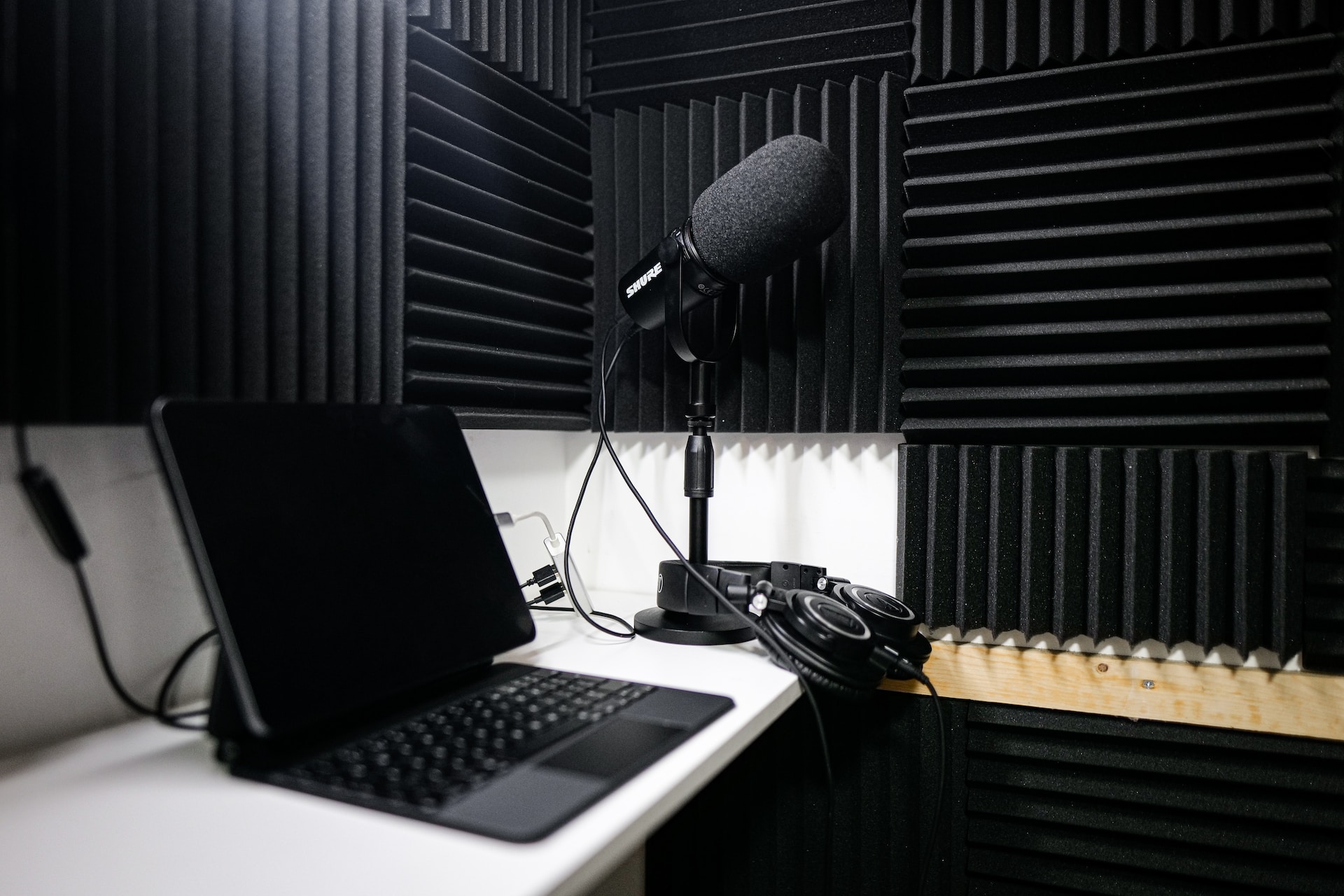 Recording studio with a microphone and laptop